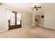 Inviting living room with double doors leading outside, a ceiling fan, and a view into adjacent rooms at 2701 E Caldwell St, Phoenix, AZ 85042