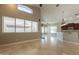 Spacious living room with tile flooring, ceiling fan and a view of the kitchen and bar area at 2701 E Caldwell St, Phoenix, AZ 85042