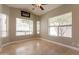 Light-filled living room with marble floors featuring multiple windows and a ceiling fan at 2701 E Caldwell St, Phoenix, AZ 85042