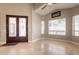 Bright and spacious living room with marble floors and ample natural light from many windows at 2701 E Caldwell St, Phoenix, AZ 85042