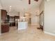 Open-concept living space with high ceilings, tile floors, and a kitchen with dark wood cabinetry at 2701 E Caldwell St, Phoenix, AZ 85042