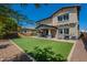 Spacious backyard with well-maintained artificial turf and a covered patio for outdoor enjoyment at 3871 E Harrison St, Gilbert, AZ 85295