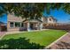 Lush artificial lawn in the backyard complemented by a covered patio and well-manicured landscaping at 3871 E Harrison St, Gilbert, AZ 85295