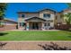 Expansive backyard featuring an artificial lawn, a covered patio, and ample space for entertaining at 3871 E Harrison St, Gilbert, AZ 85295