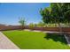 The backyard features low-maintenance artificial turf, landscaping, and a privacy fence at 3871 E Harrison St, Gilbert, AZ 85295