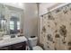 Bathroom with a single vanity, a mirror, a toilet, and a shower with a floral curtain at 3871 E Harrison St, Gilbert, AZ 85295
