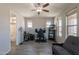 Bedroom with a ceiling fan, a futon, and a desk, offering a versatile space with bathroom access at 3871 E Harrison St, Gilbert, AZ 85295