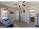 Bedroom featuring a ceiling fan, a futon, and is next to a bathroom and hallway at 3871 E Harrison St, Gilbert, AZ 85295
