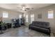 Bedroom with a ceiling fan, a futon, and a desk, offering a versatile space for relaxation and work at 3871 E Harrison St, Gilbert, AZ 85295