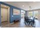Inviting dining room featuring a wooden table and seating, stylish lighting, and access to the backyard at 3871 E Harrison St, Gilbert, AZ 85295
