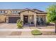 Charming home with a well-manicured lawn, desert landscaping, a covered porch, and brick paver driveway at 3871 E Harrison St, Gilbert, AZ 85295