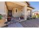 Charming front porch with stone columns, comfortable seating, and desert landscaping at 3871 E Harrison St, Gilbert, AZ 85295