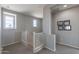 Upstairs hallway with carpet and windows; view of the stairwell and second story railing at 3871 E Harrison St, Gilbert, AZ 85295
