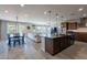 Open-concept kitchen with an island, pendant lighting, stainless steel appliances, and seamless flow to the living area at 3871 E Harrison St, Gilbert, AZ 85295