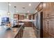 Well-equipped kitchen with stainless steel appliances, wooden cabinets, and a large center island at 3871 E Harrison St, Gilbert, AZ 85295