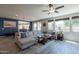 Spacious living room showcasing large windows, a ceiling fan, and a comfortable sectional sofa at 3871 E Harrison St, Gilbert, AZ 85295