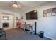 Cozy living room with ceiling fan, carpet, TV, and movie theme decor and vintage style popcorn machine at 3871 E Harrison St, Gilbert, AZ 85295