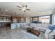 Open floor plan living room view into the modern kitchen and features a large sectional sofa at 3871 E Harrison St, Gilbert, AZ 85295