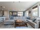 Bright living room with a large sectional sofa, view of the dining area, and an open floor plan at 3871 E Harrison St, Gilbert, AZ 85295