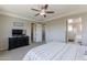Carpeted main bedroom featuring a ceiling fan and doorway to the en-suite bath at 3871 E Harrison St, Gilbert, AZ 85295