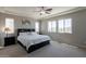 Primary bedroom featuring neutral paint, carpet, tray ceiling, and large windows at 3871 E Harrison St, Gilbert, AZ 85295
