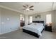 Primary bedroom boasting neutral paint, carpet, tray ceiling, and en-suite bathroom access at 3871 E Harrison St, Gilbert, AZ 85295