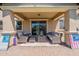 A covered patio features stylish seating and decor, seamlessly blending indoor and outdoor living at 3871 E Harrison St, Gilbert, AZ 85295