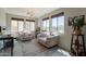 Bright sitting room featuring several windows, comfortable seating, accent rug, and a stylish modern chandelier at 3871 E Harrison St, Gilbert, AZ 85295