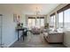 Bright sitting room with large windows, comfortable seating, accent rug, and a stylish modern chandelier at 3871 E Harrison St, Gilbert, AZ 85295