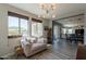 Bright sitting room featuring many windows, comfortable seating, accent rug, and is open to dining room at 3871 E Harrison St, Gilbert, AZ 85295