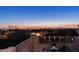 Enjoy spectacular sunset views from this home's private balcony overlooking the city and distant mountains at twilight at 4332 N Santiago Cir, Mesa, AZ 85215