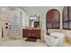 Luxurious bathroom featuring a soaking tub, glass block shower, and granite vanity for a spa-like experience at 4332 N Santiago Cir, Mesa, AZ 85215