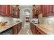 Butler's pantry with granite counters, dark cabinets and wine storage at 4332 N Santiago Cir, Mesa, AZ 85215