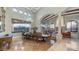 Spacious dining room with large windows, elegant chandelier, and beautiful stone columns and archway at 4332 N Santiago Cir, Mesa, AZ 85215