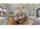 Elegant dining room features high ceilings, large windows, and a grand table perfect for entertaining guests at 4332 N Santiago Cir, Mesa, AZ 85215