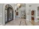 Grand foyer with wrought iron door, staircase, and light-colored tile at 4332 N Santiago Cir, Mesa, AZ 85215