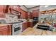 Close up kitchen view with stainless steel range and oven, and dark wood cabinetry at 4332 N Santiago Cir, Mesa, AZ 85215