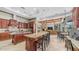 Open concept kitchen with dark wood cabinets, granite countertops, and an island with seating at 4332 N Santiago Cir, Mesa, AZ 85215