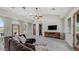 Spacious living room with high ceilings, a ceiling fan, a brown couch, and a television at 4332 N Santiago Cir, Mesa, AZ 85215