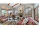 Cozy living room with stone fireplace, beamed ceilings, and an outside view at 4332 N Santiago Cir, Mesa, AZ 85215