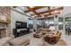 Comfortable living room with stone fireplace, beamed ceilings and outdoor view at 4332 N Santiago Cir, Mesa, AZ 85215