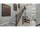 Elegant staircase with wrought iron railing ascends to the upper level, complemented by unique wall art at 4332 N Santiago Cir, Mesa, AZ 85215