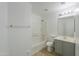 Bright bathroom featuring a tiled shower/bath combo, a vanity with storage, and modern fixtures at 43601 W Cowpath Rd, Maricopa, AZ 85138