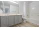 The bathroom includes a double sink vanity and tiled shower and tub at 43601 W Cowpath Rd, Maricopa, AZ 85138