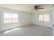 Spacious carpeted bedroom featuring large windows and plenty of natural light at 43601 W Cowpath Rd, Maricopa, AZ 85138