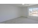 This carpeted bedroom features a large window to let in natural light at 43601 W Cowpath Rd, Maricopa, AZ 85138
