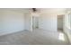 Spacious carpeted bedroom with large windows and multiple access points at 43601 W Cowpath Rd, Maricopa, AZ 85138