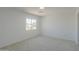 A bright carpeted bedroom features a large window and white walls at 43601 W Cowpath Rd, Maricopa, AZ 85138