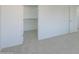 The bedroom features carpet and a walk-in closet for storage at 43601 W Cowpath Rd, Maricopa, AZ 85138