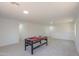 A large, carpeted game room provides great space for activities at 43601 W Cowpath Rd, Maricopa, AZ 85138